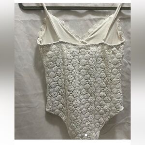 Super cute white floral body suit.